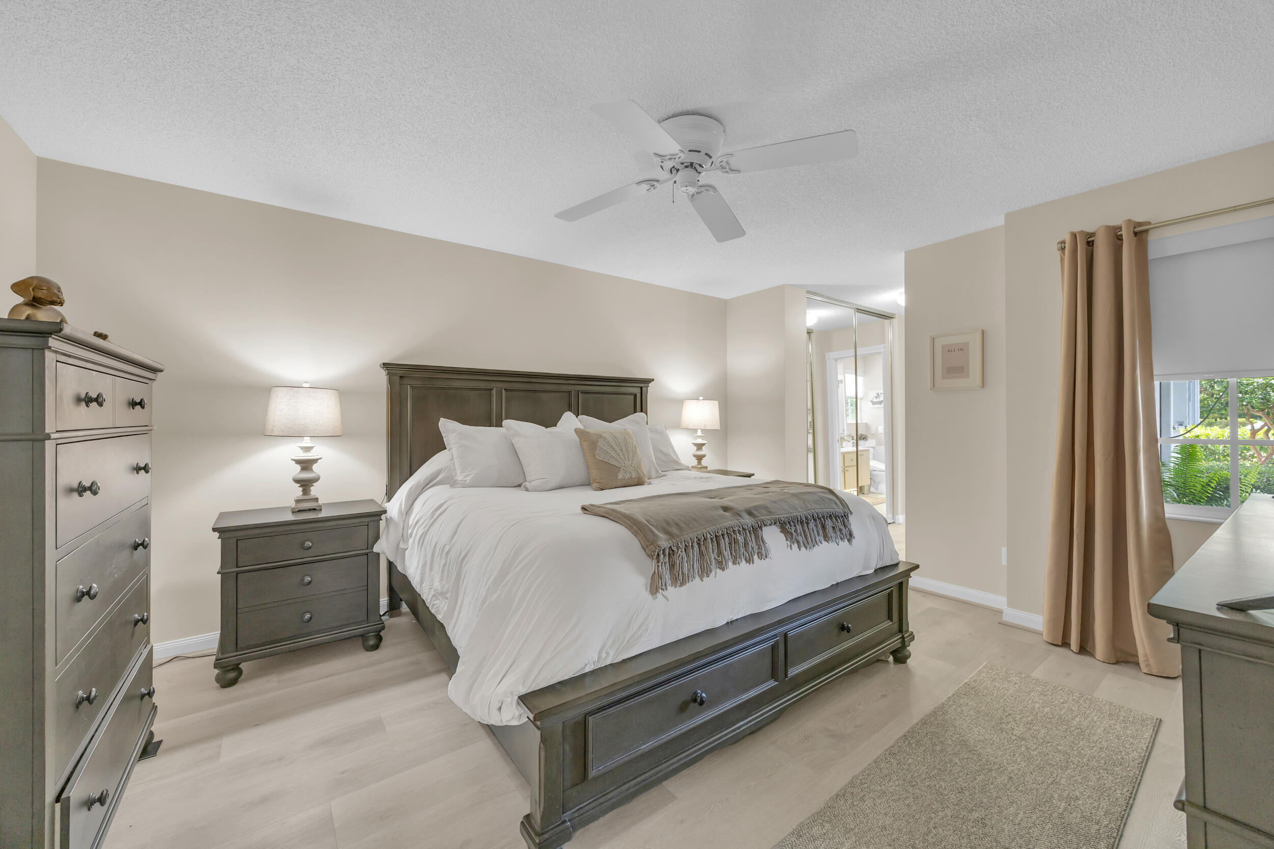 233 Brier Circle Jupiter, FL 33458 - Photo 17 of 31 a spacious bedroom with a bed and a dresser