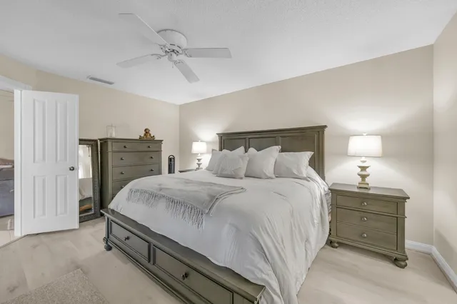 a bedroom with a bed and a chandelier