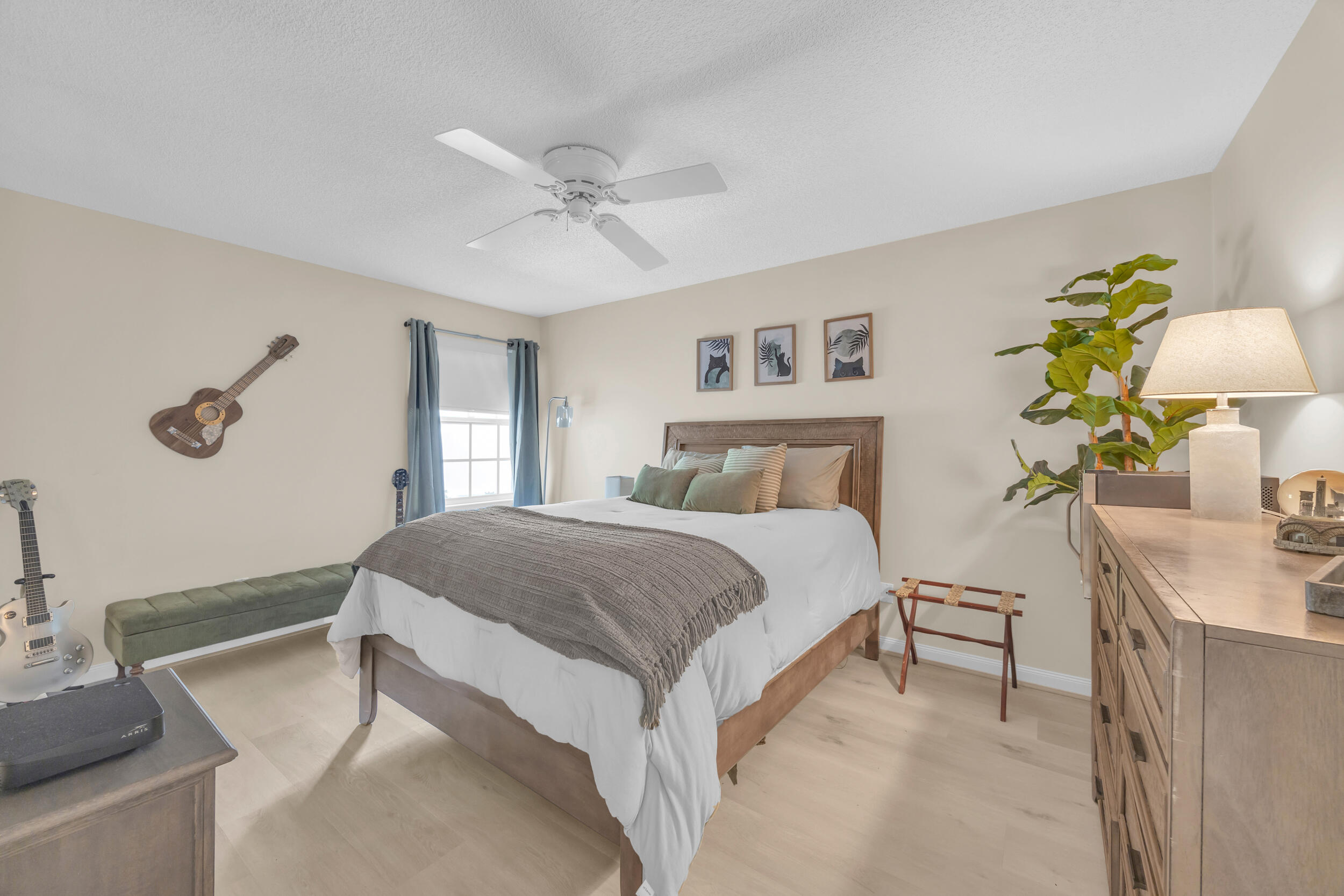 233 Brier Circle Jupiter, FL 33458 - Photo 22 of 31 a bedroom with a bed and a chandelier