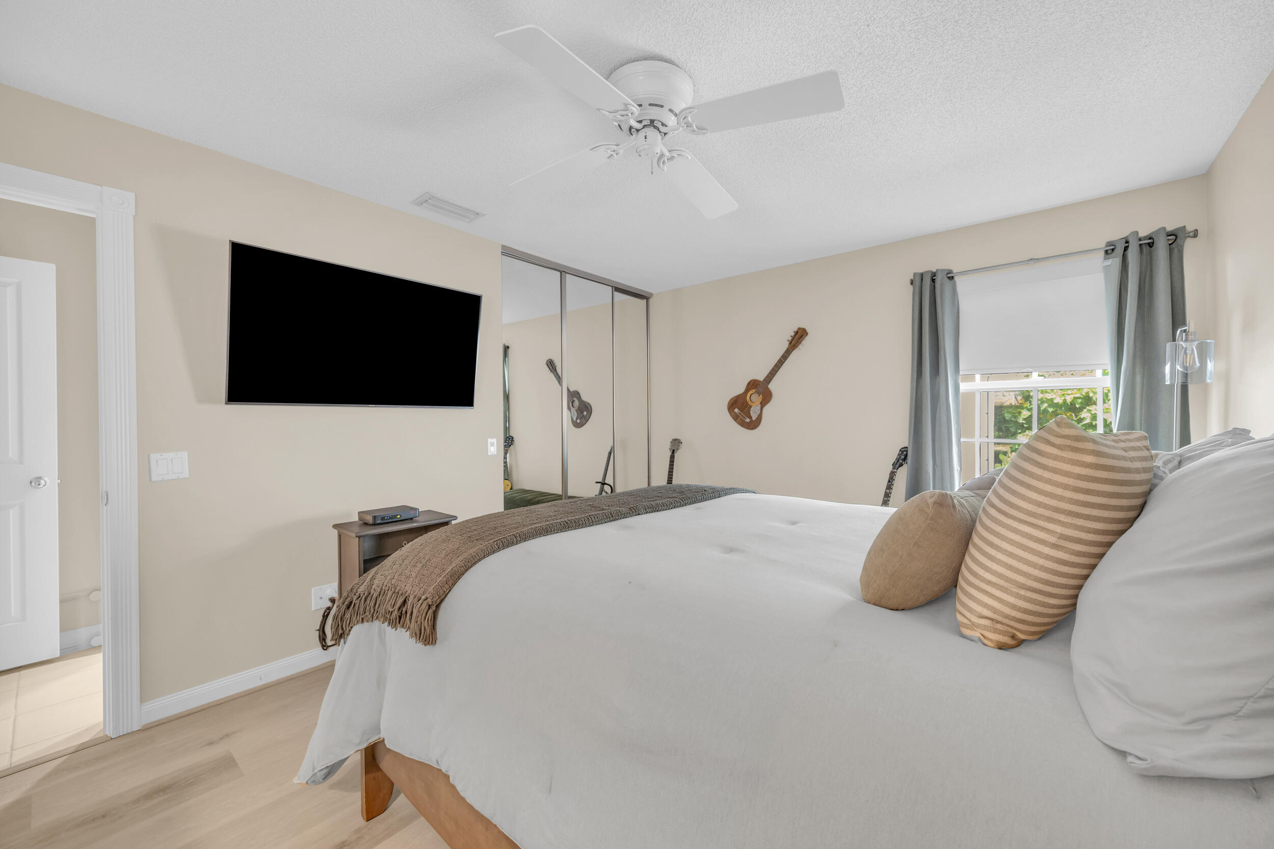 233 Brier Circle Jupiter, FL 33458 - Photo 23 of 31 a bedroom with a bed and a flat screen tv