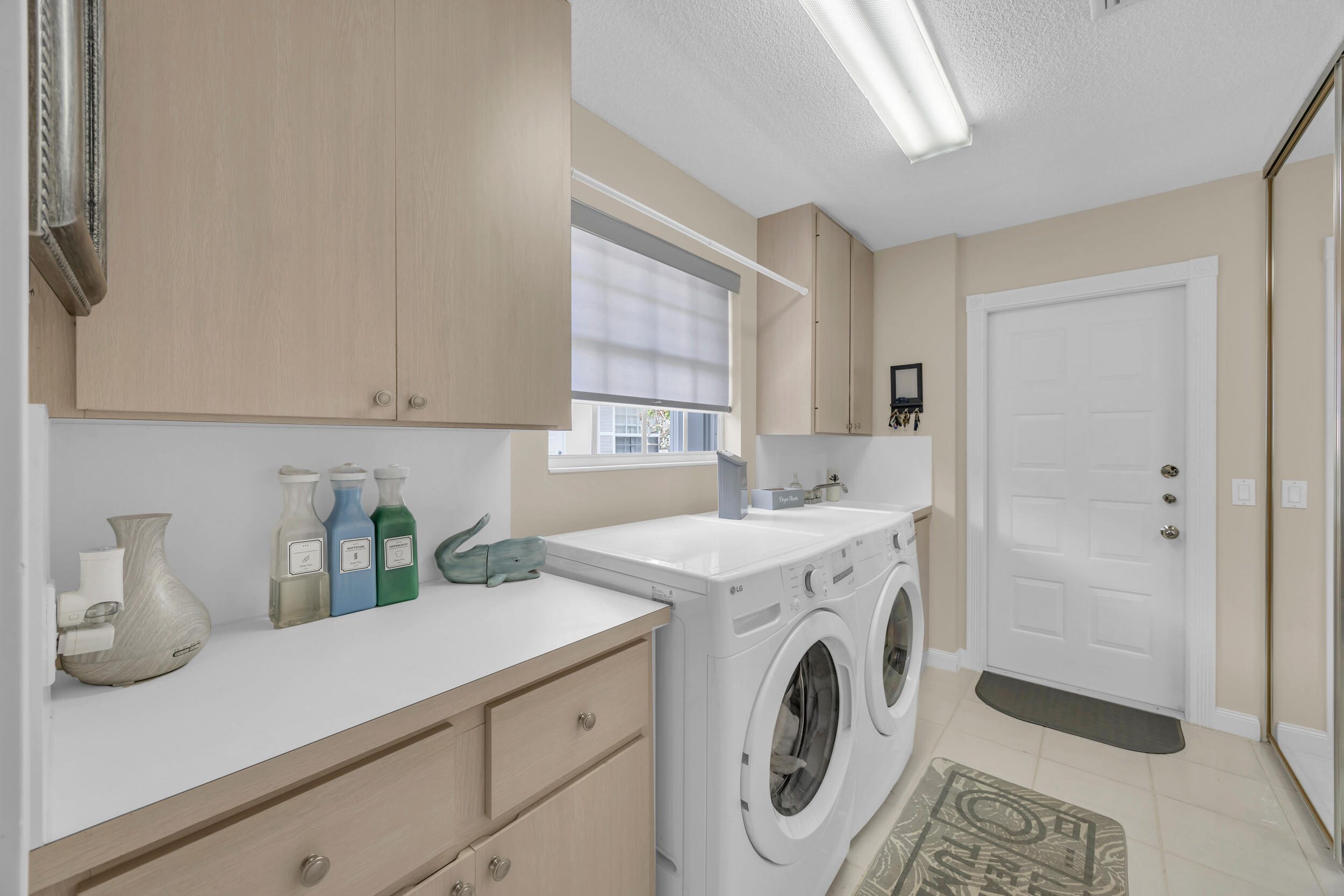 233 Brier Circle Jupiter, FL 33458 - Photo 25 of 31 a utility room with sink dryer and washer