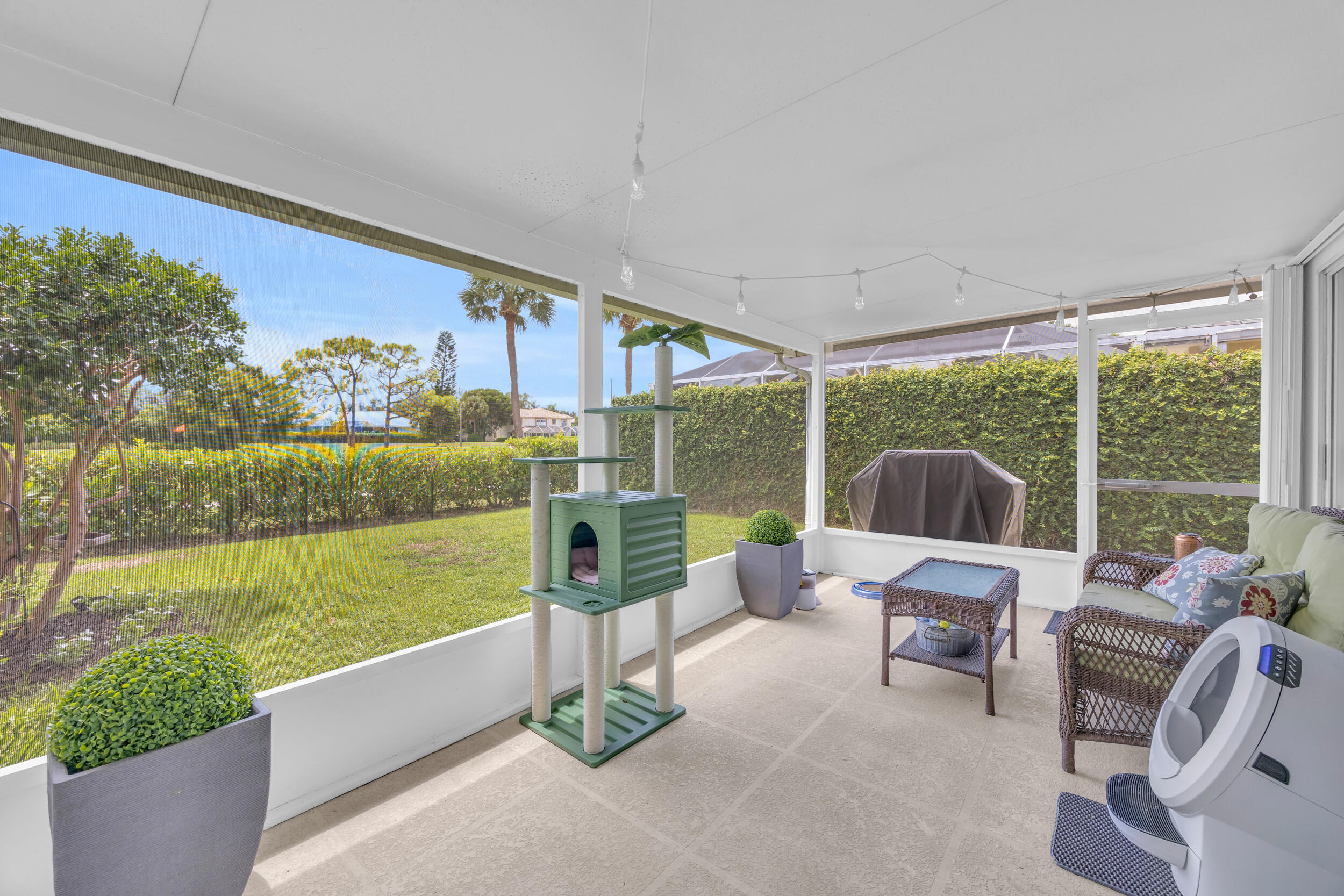 233 Brier Circle Jupiter, FL 33458 - Photo 28 of 31 a living room with couch floor to ceiling window and yard