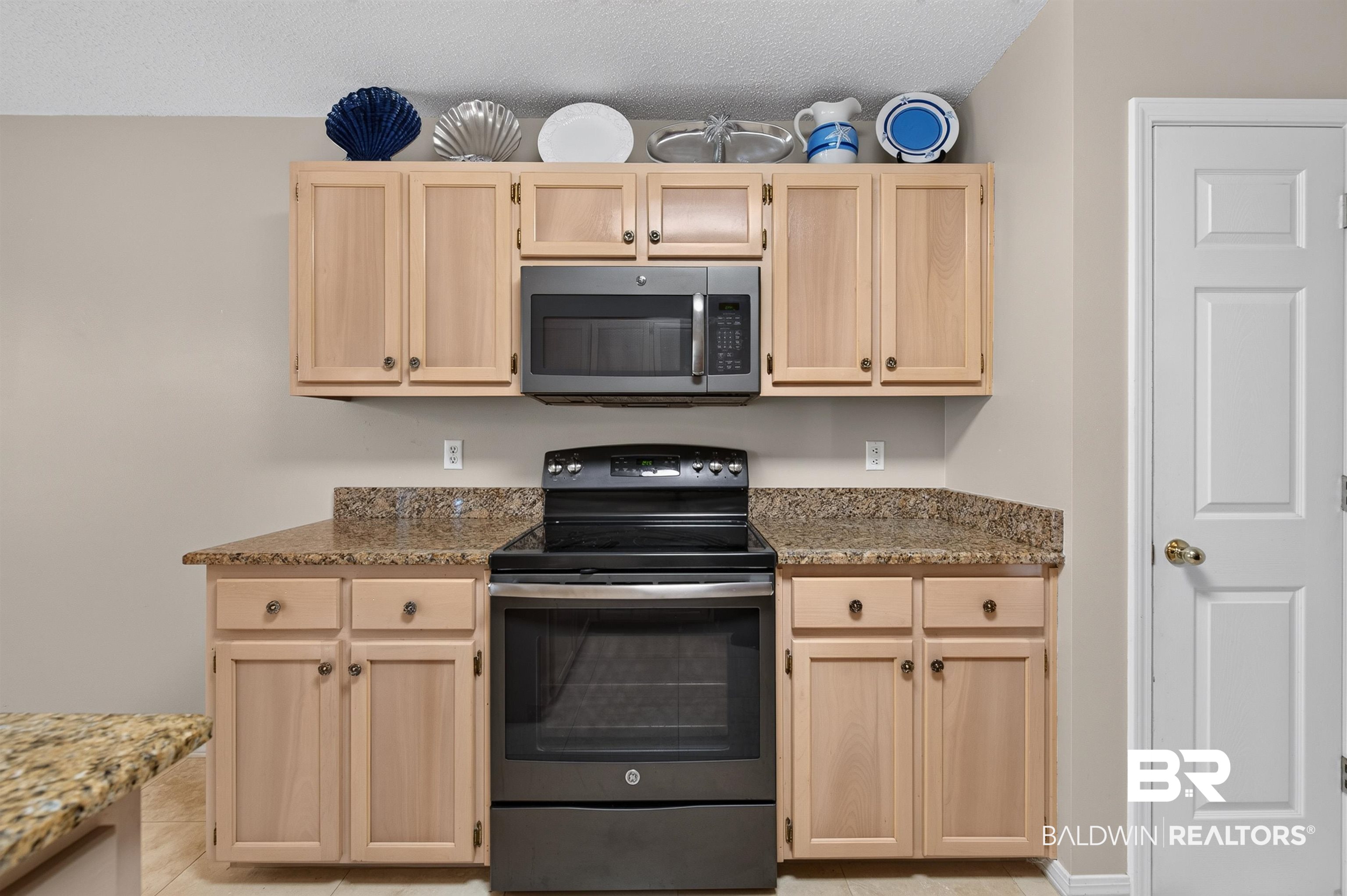 22685 County Road 12 Foley, AL 36535 - Photo 45 of 89 Kitchen featuring light wood-finish cabinetry, speckled countertops, and a black oven with an overhead microwave
