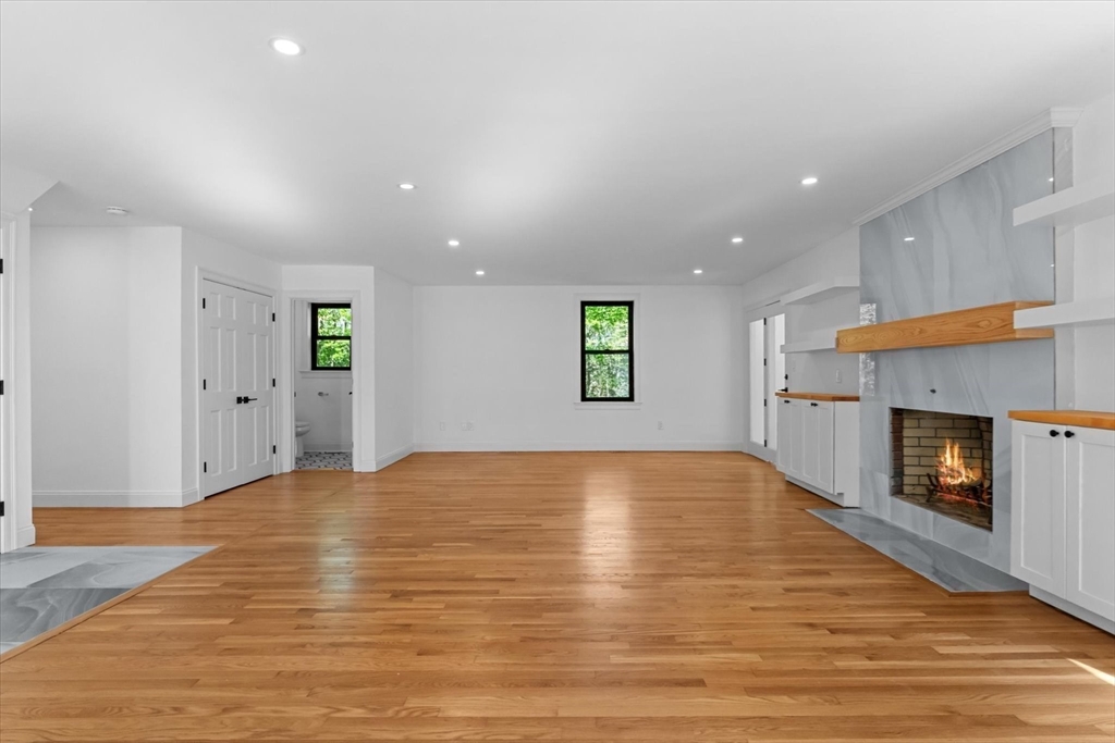 7 Garden Road Wellesley, MA 02481 - Photo 11 of 39 a view of an empty room with a fireplace and a window