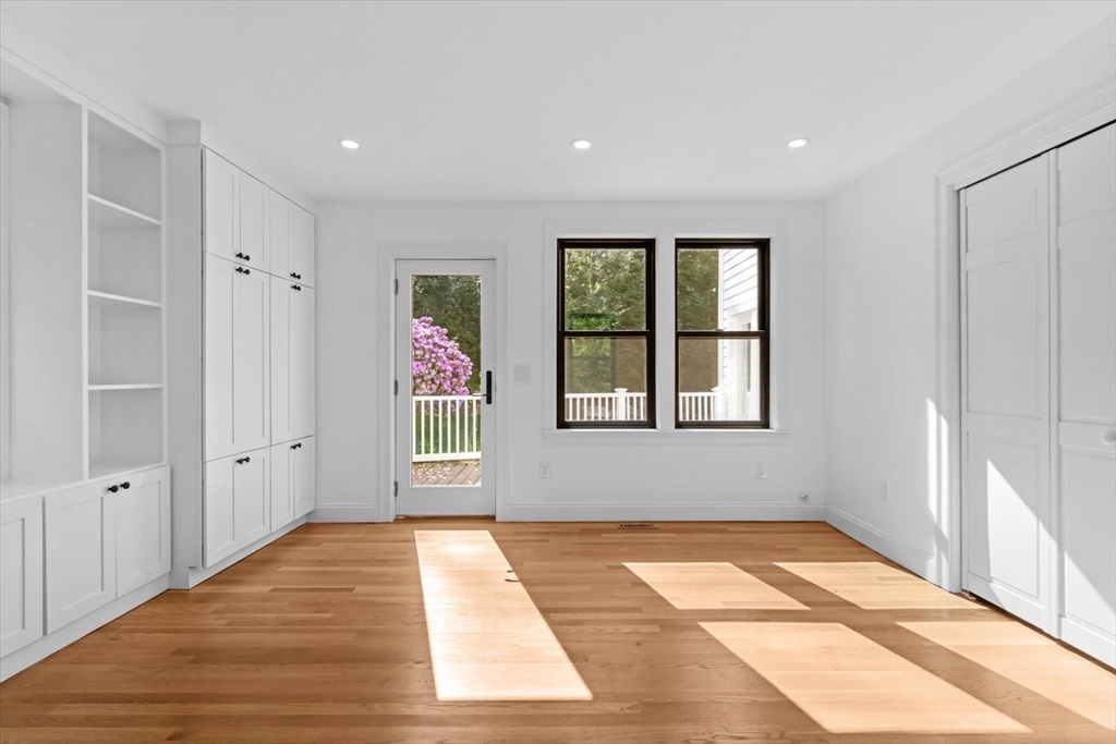 7 Garden Road Wellesley, MA 02481 - Photo 23 of 39 a view of an empty room with wooden floor and a window