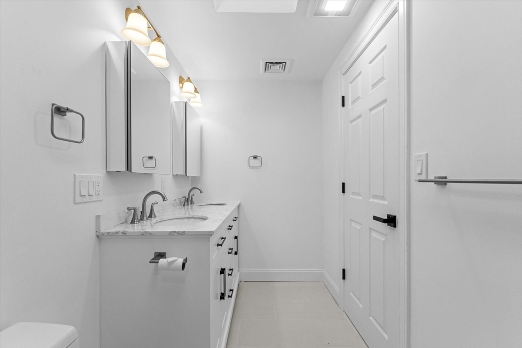 7 Garden Road Wellesley, MA 02481 - Photo 27 of 39 a bathroom with a double vanity sink mirror and toilet