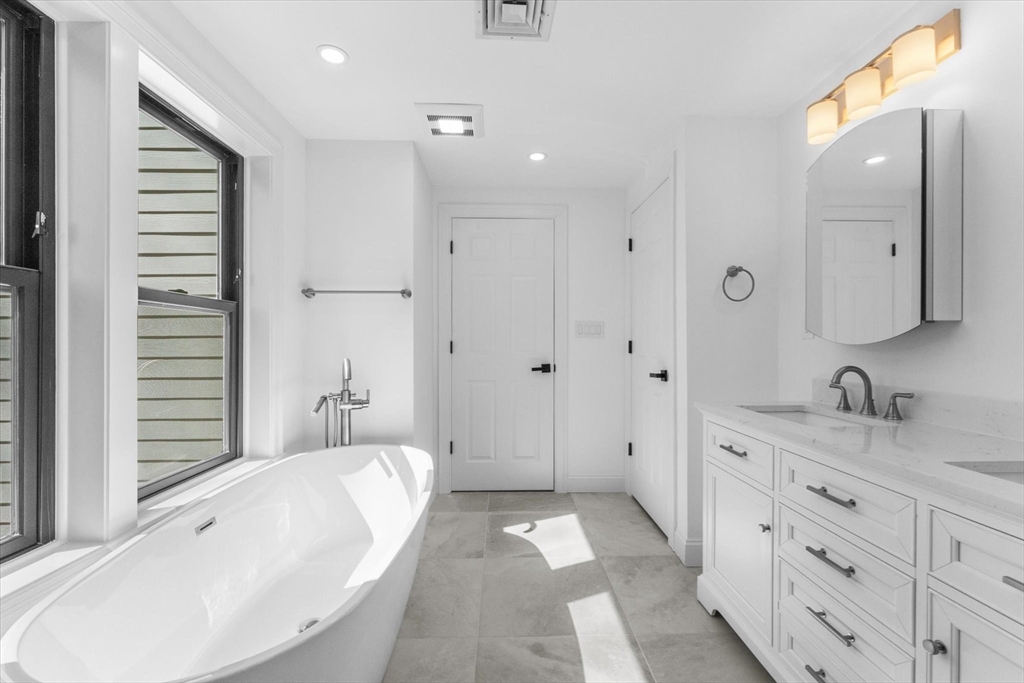 7 Garden Road Wellesley, MA 02481 - Photo 28 of 39 a spacious bathroom with sinks mirror and a bathtub
