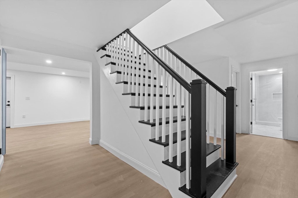 7 Garden Road Wellesley, MA 02481 - Photo 35 of 39 wooden floor with staircase and white walls