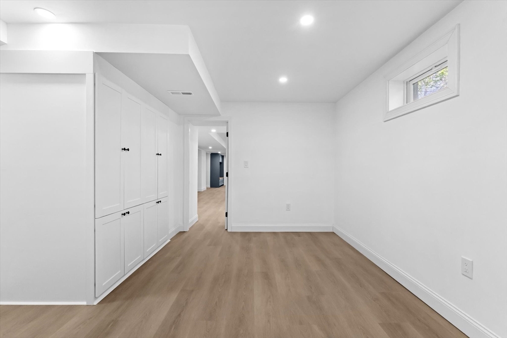 7 Garden Road Wellesley, MA 02481 - Photo 38 of 39 a view of room with walk in closet and wooden floor