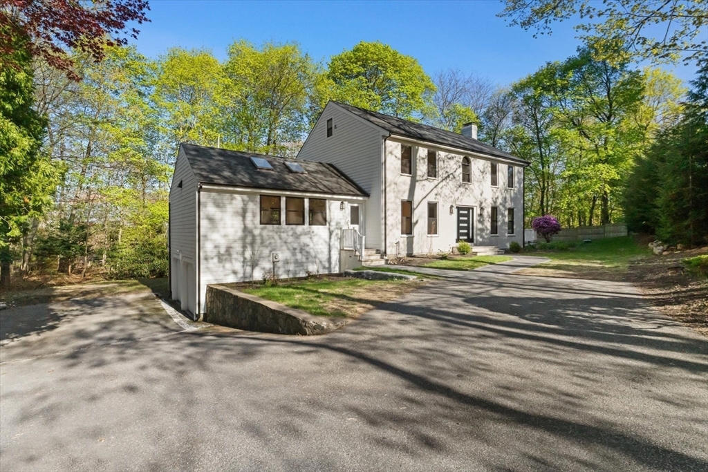 7 Garden Road Wellesley, MA 02481 - Photo 5 of 39 a view of a house with a big yard and large trees