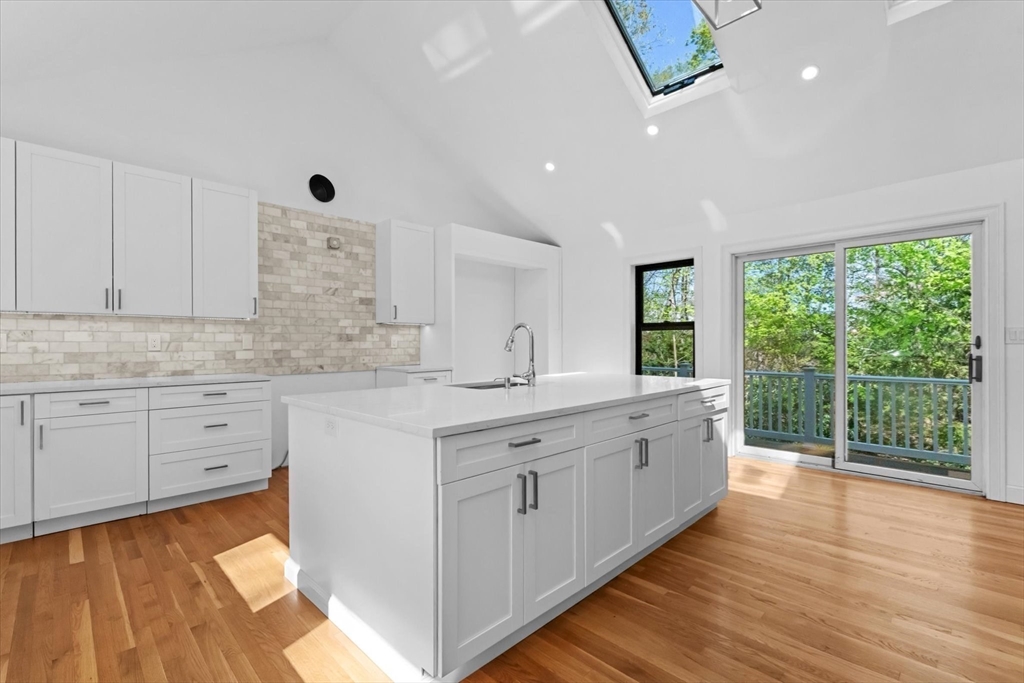 7 Garden Road Wellesley, MA 02481 - Photo 8 of 39 a large kitchen with kitchen island white cabinets and wooden floor