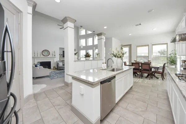 a large white kitchen with a large window