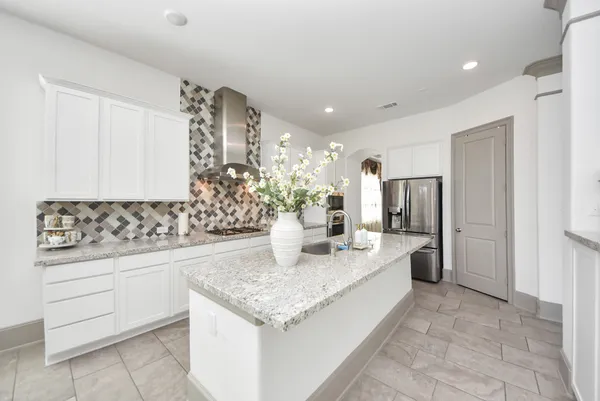 a kitchen with stainless steel appliances granite countertop a sink and cabinets