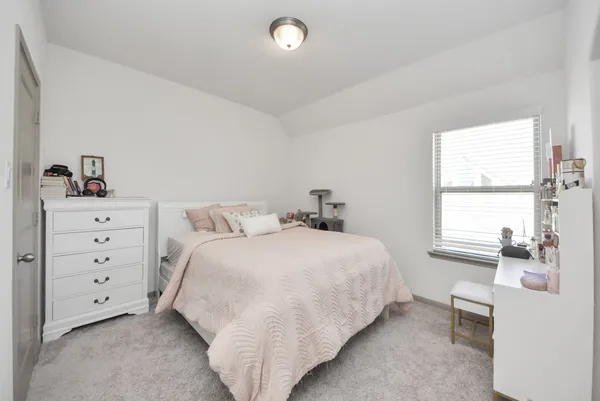 a bedroom with a bed and window