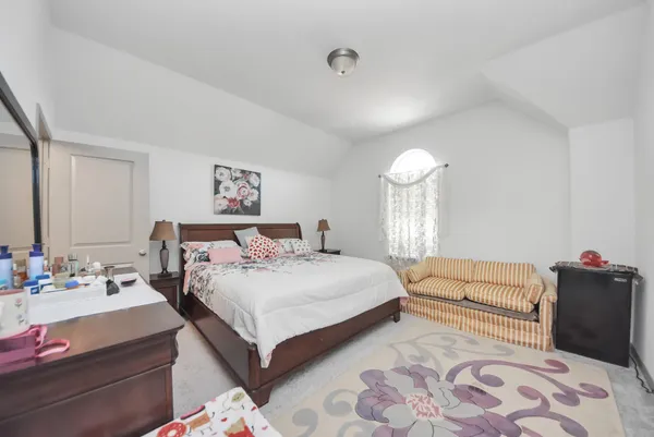 a bedroom with a bed and a couch