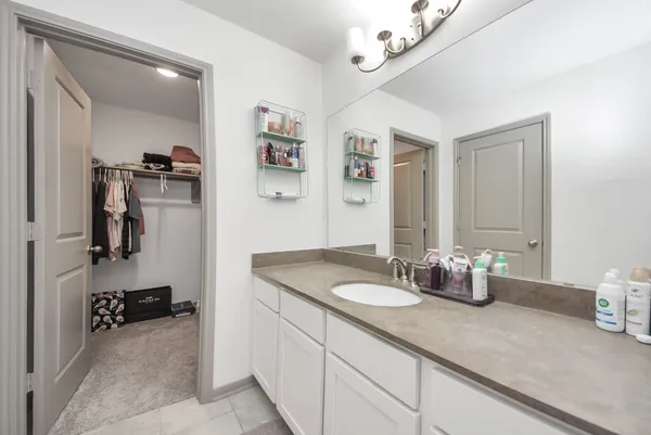 a bathroom with a sink a vanity and a mirror
