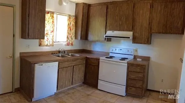 a kitchen with appliances cabinets and a sink