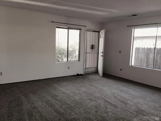 a view of an empty room with a window
