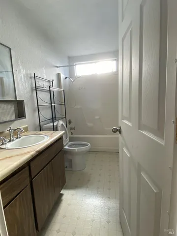 a bathroom with a double vanity sink toilet and mirror