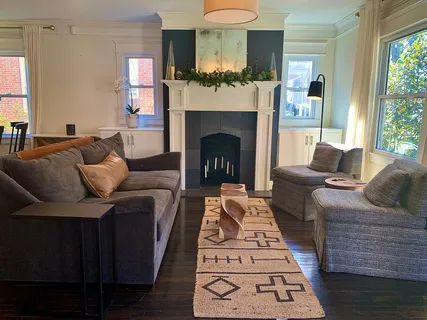 a living room with furniture and a fireplace