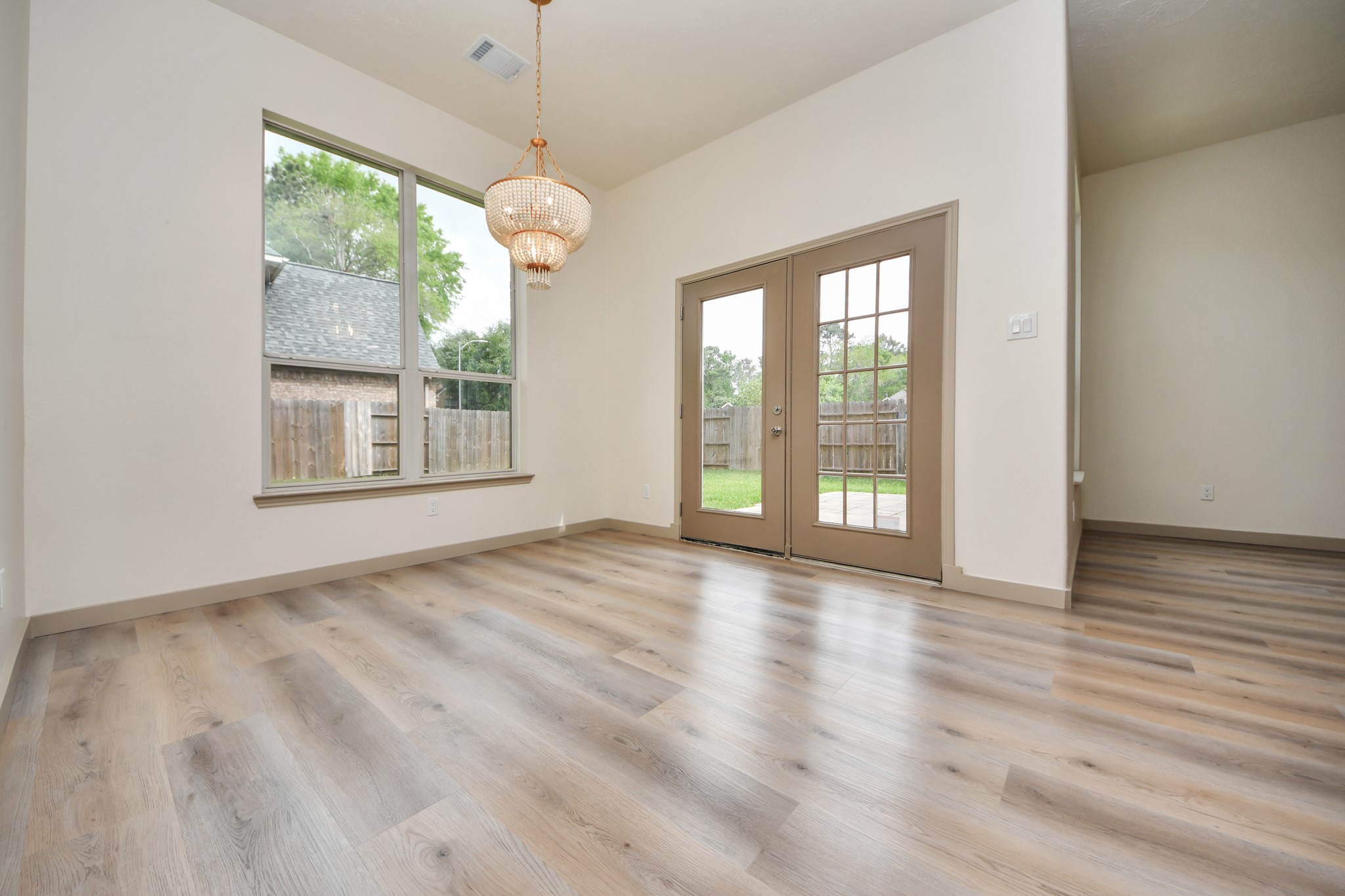 14423 Gadwall Court Houston, TX 77044 - Photo 23 of 42 a view of an empty room with wooden floor and a window