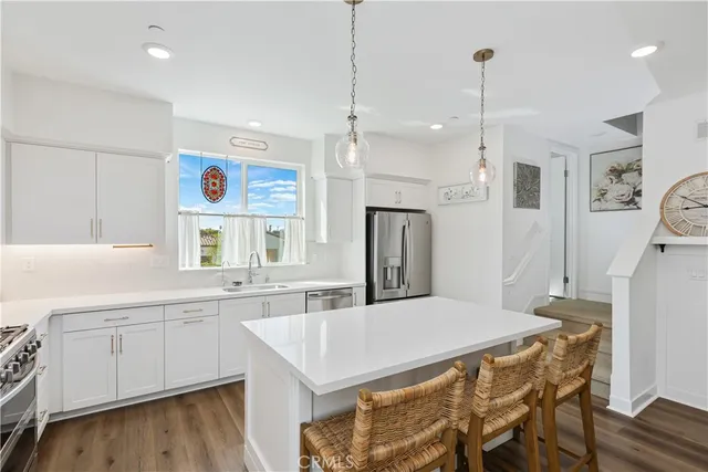 a kitchen with a table chairs refrigerator and microwave