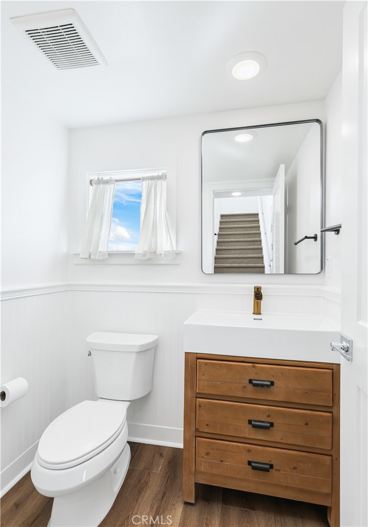 2317 West Broadway, Unit 96 Anaheim, CA 92804 - Photo 14 of 52 a bathroom with a toilet a sink and mirror