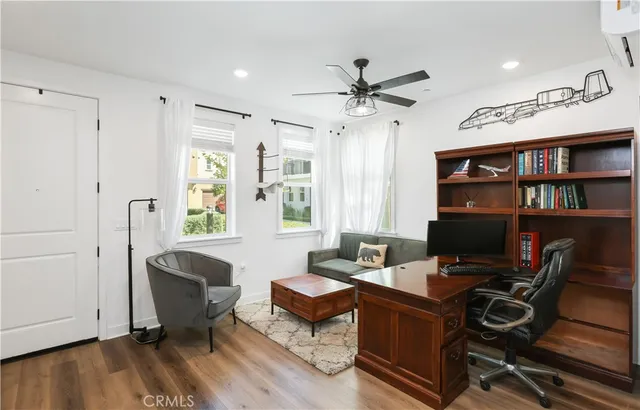 a view of a workspace with furniture and a window