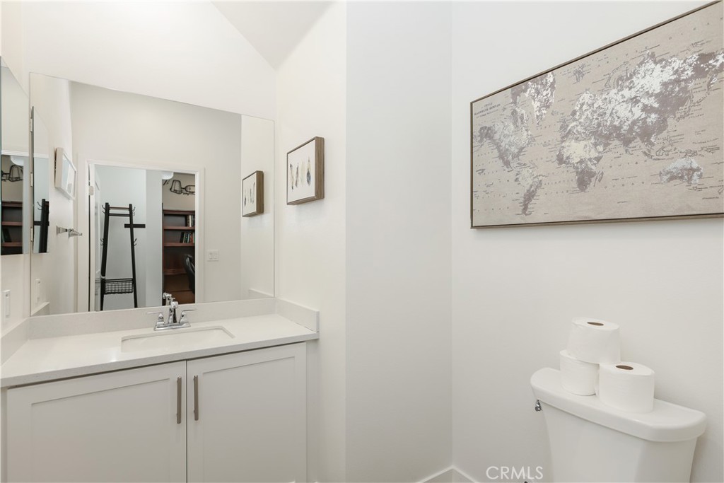 2317 West Broadway, Unit 96 Anaheim, CA 92804 - Photo 21 of 52 a bathroom with a toilet a sink and mirror