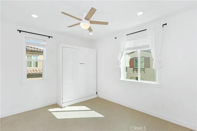 an empty room with windows and closet