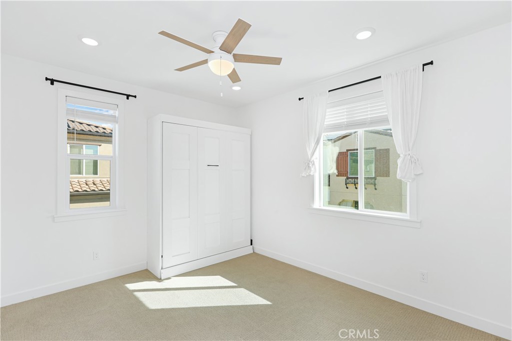 2317 West Broadway, Unit 96 Anaheim, CA 92804 - Photo 23 of 52 an empty room with windows and closet