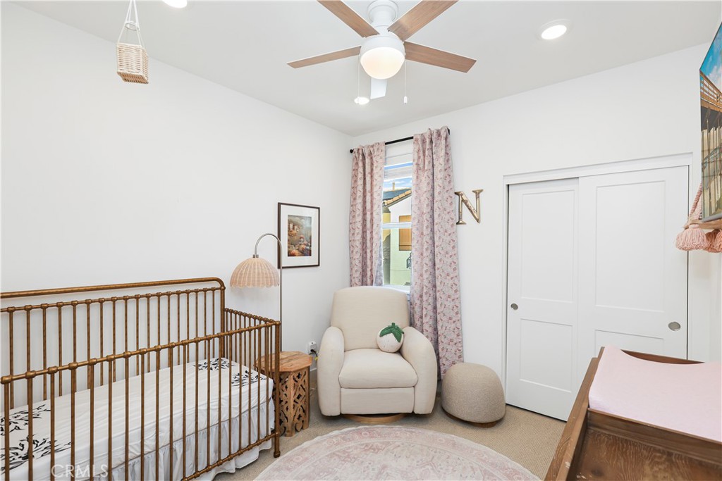 2317 West Broadway, Unit 96 Anaheim, CA 92804 - Photo 24 of 52 a bedroom with a bed and a chandelier