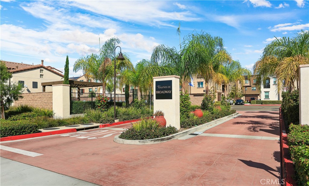 2317 West Broadway, Unit 96 Anaheim, CA 92804 - Photo 36 of 52 a front view of a house with a yard and potted plants