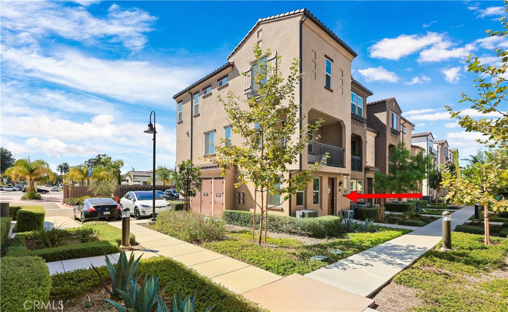 2317 West Broadway, Unit 96 Anaheim, CA 92804 - Photo 42 of 52 a front view of multi story residential apartment building with yard and sign board