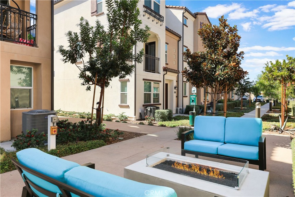2317 West Broadway, Unit 96 Anaheim, CA 92804 - Photo 43 of 52 a view of a patio with couches and a potted plant on a table and chairs