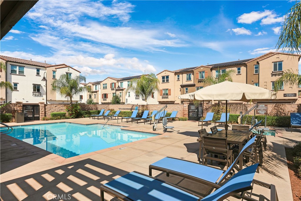 2317 West Broadway, Unit 96 Anaheim, CA 92804 - Photo 49 of 52 a roof deck with table and chairs under an umbrella