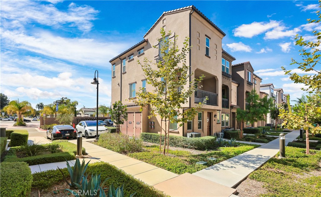 2317 West Broadway, Unit 96 Anaheim, CA 92804 - Photo 50 of 52 a front view of a building with garden and plants