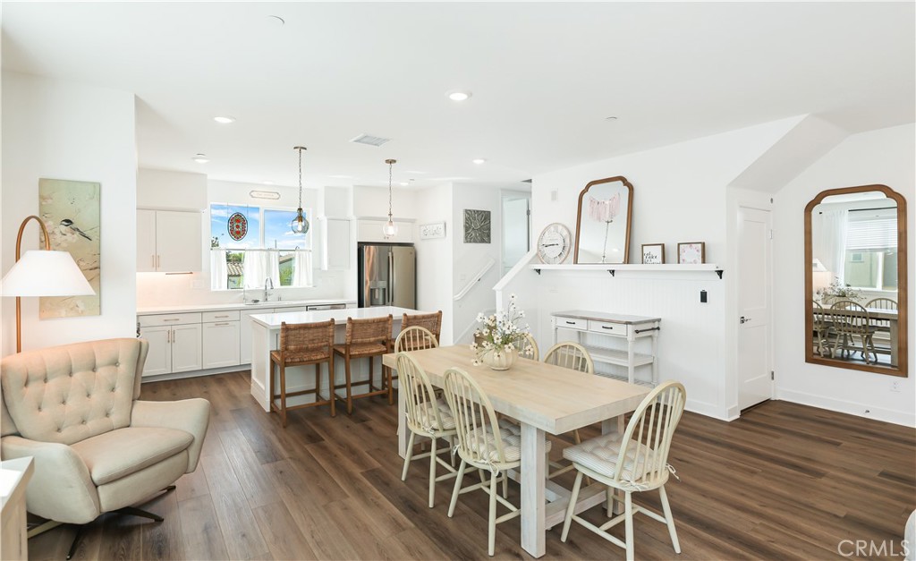 2317 West Broadway, Unit 96 Anaheim, CA 92804 - Photo 9 of 52 a view of a dining room with furniture and wooden floor