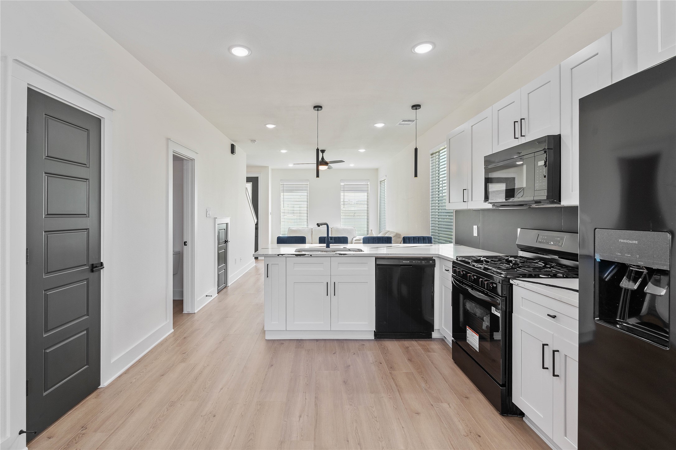 3522 Mansfield Street Houston, TX 77091 - Photo 11 of 18 a large kitchen with stainless steel appliances granite countertop a large stove top oven a refrigerator a sink and dishwasher with wooden floor