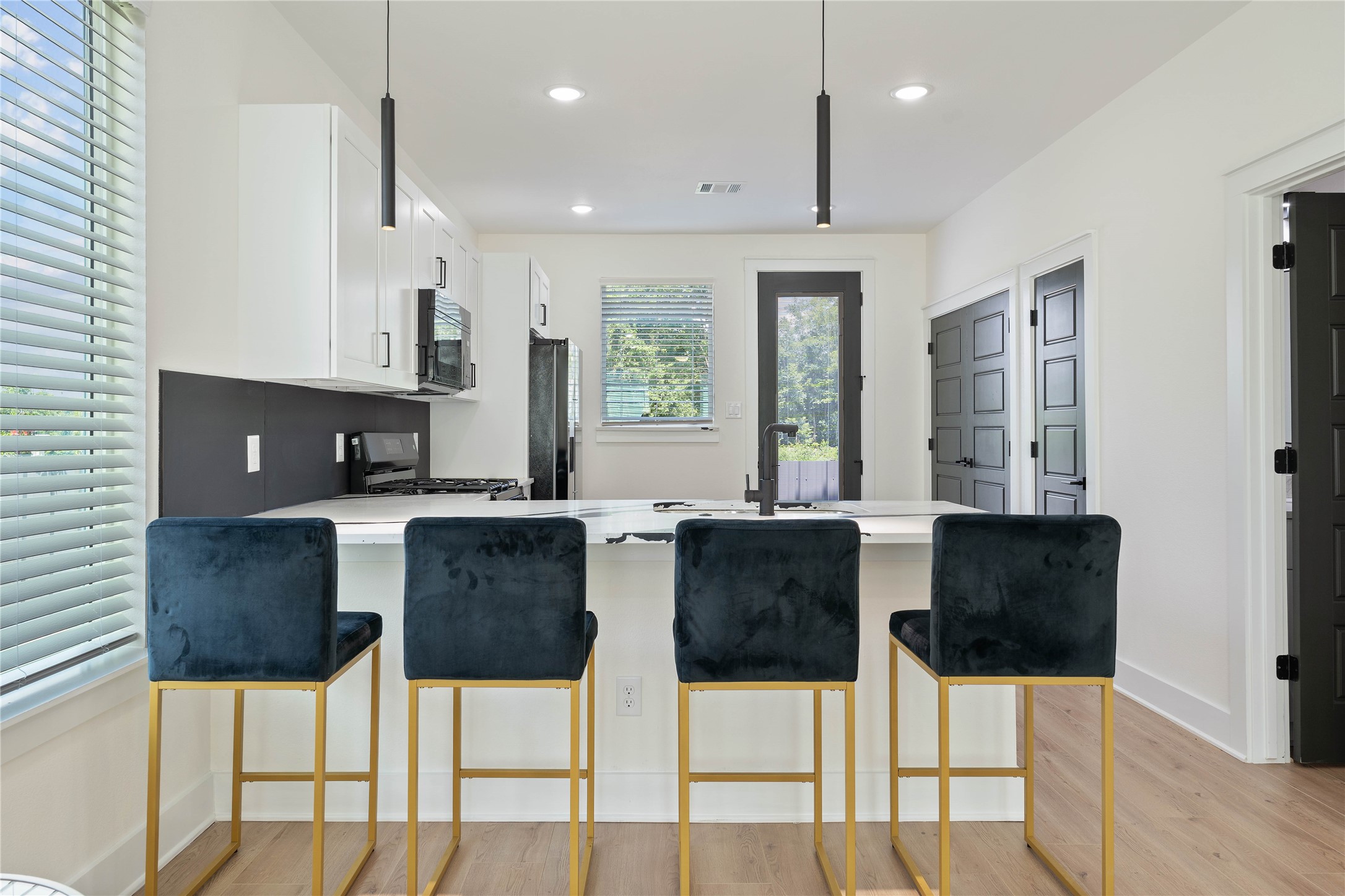 3522 Mansfield Street Houston, TX 77091 - Photo 9 of 18 a kitchen with stainless steel appliances kitchen island granite countertop a table and chairs in it