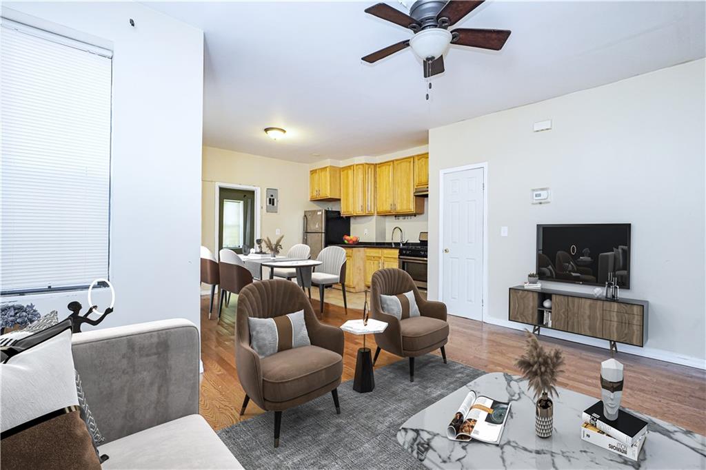 587 Van Siclen Avenue Brooklyn, NY 11207 - Photo 13 of 34 a living room with furniture and a flat screen tv