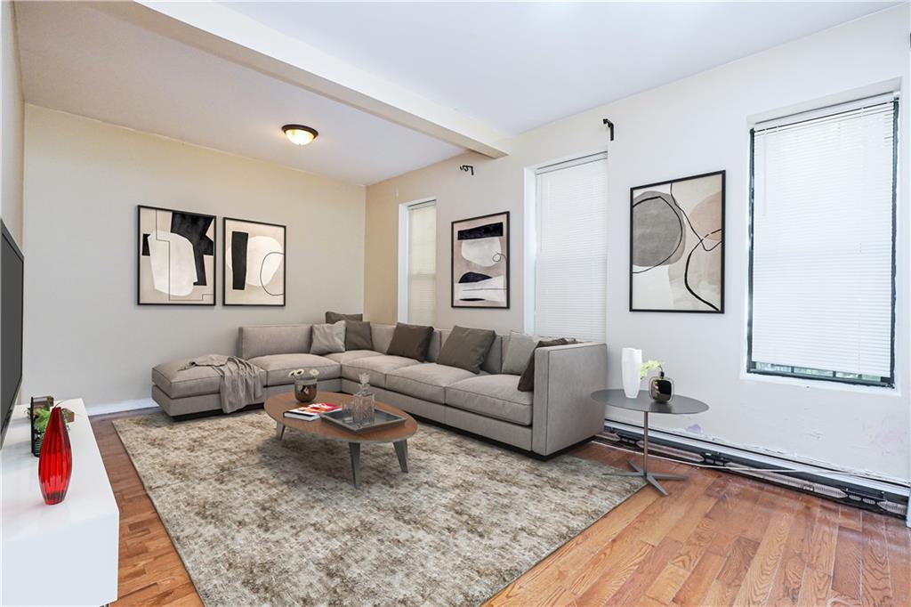 587 Van Siclen Avenue Brooklyn, NY 11207 - Photo 16 of 34 a living room with furniture or couch and a lamp