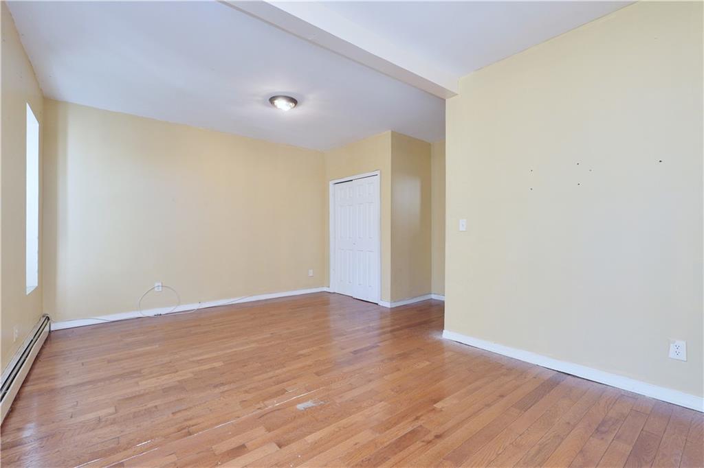 587 Van Siclen Avenue Brooklyn, NY 11207 - Photo 17 of 34 a view of an empty room with wooden floor