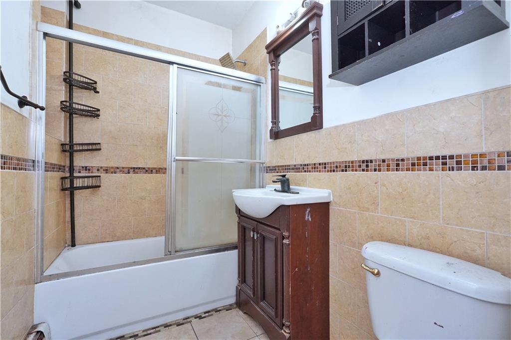 587 Van Siclen Avenue Brooklyn, NY 11207 - Photo 18 of 34 a bathroom with a sink a toilet and shower