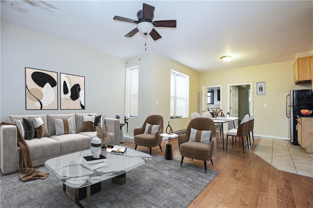 587 Van Siclen Avenue Brooklyn, NY 11207 - Photo 19 of 34 a living room with furniture a rug and a chandelier