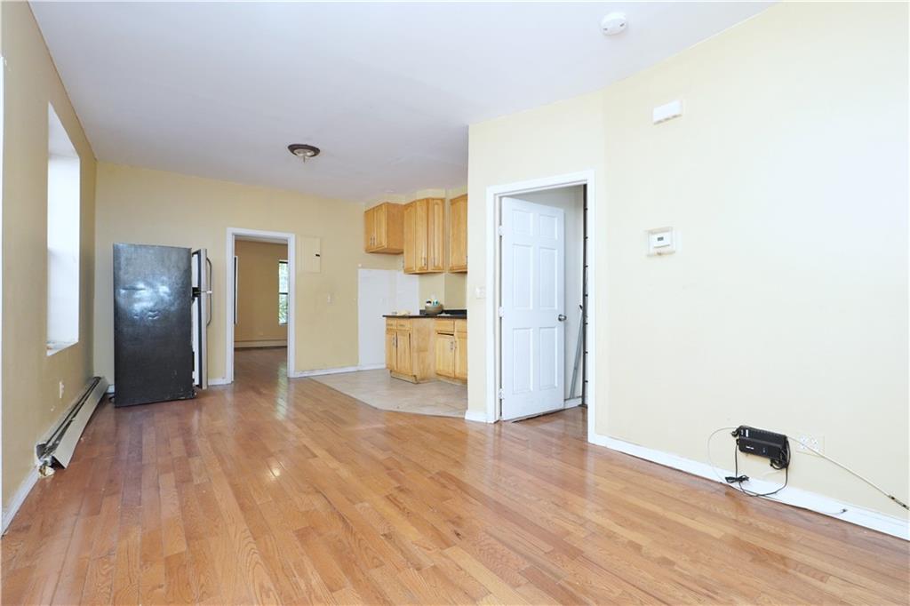587 Van Siclen Avenue Brooklyn, NY 11207 - Photo 22 of 34 a view of a kitchen with a refrigerator and a stove top oven