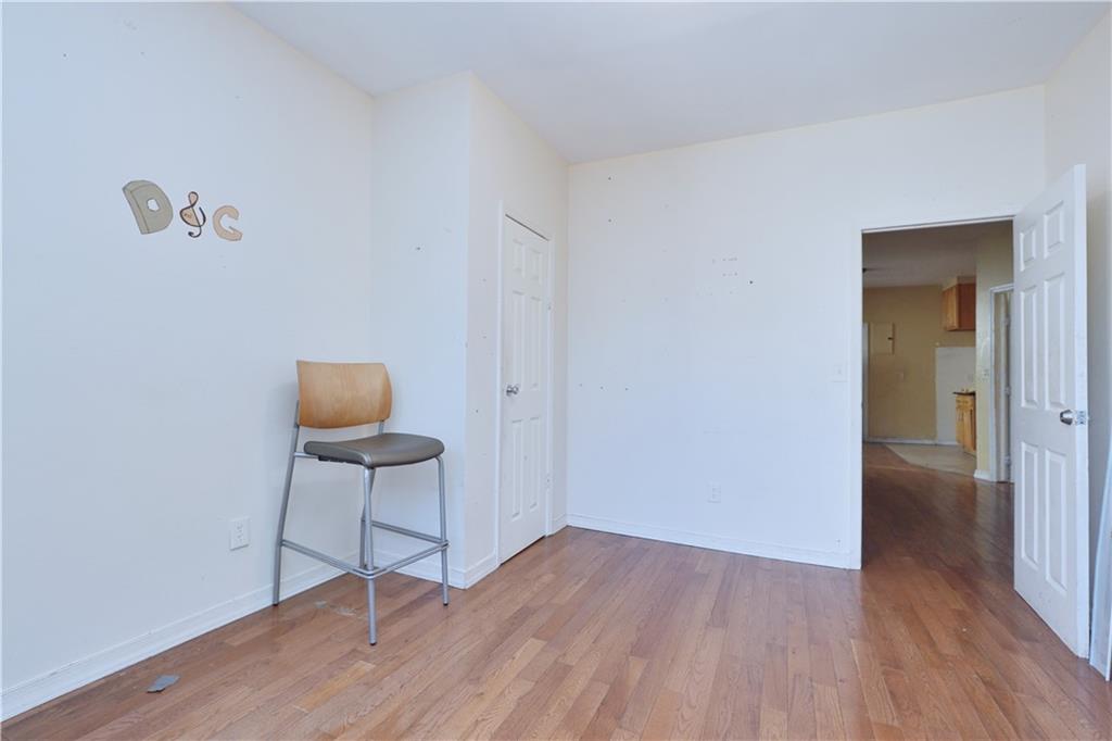 587 Van Siclen Avenue Brooklyn, NY 11207 - Photo 9 of 34 a view of an empty room and wooden floor