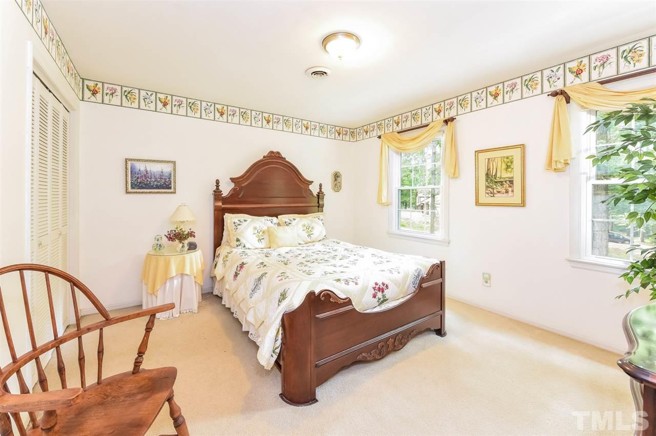 9716 Rock Creek Road Raleigh, NC 27613 - Photo 19 of 25 a bed sitting in a bedroom next to a window