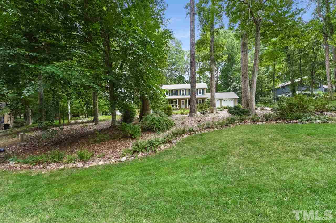 9716 Rock Creek Road Raleigh, NC 27613 - Photo 2 of 25 a view of a backyard with large trees