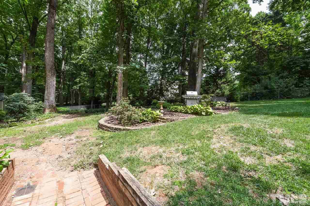 9716 Rock Creek Road Raleigh, NC 27613 - Photo 24 of 25 a view of a garden with a fountain